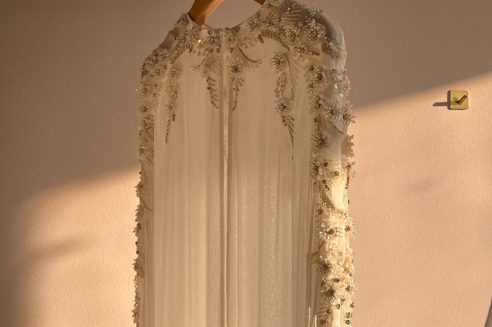 Our hand beaded Aubrey Cape illuminated by the afternoon sunlight in the Bo & Luca Studio